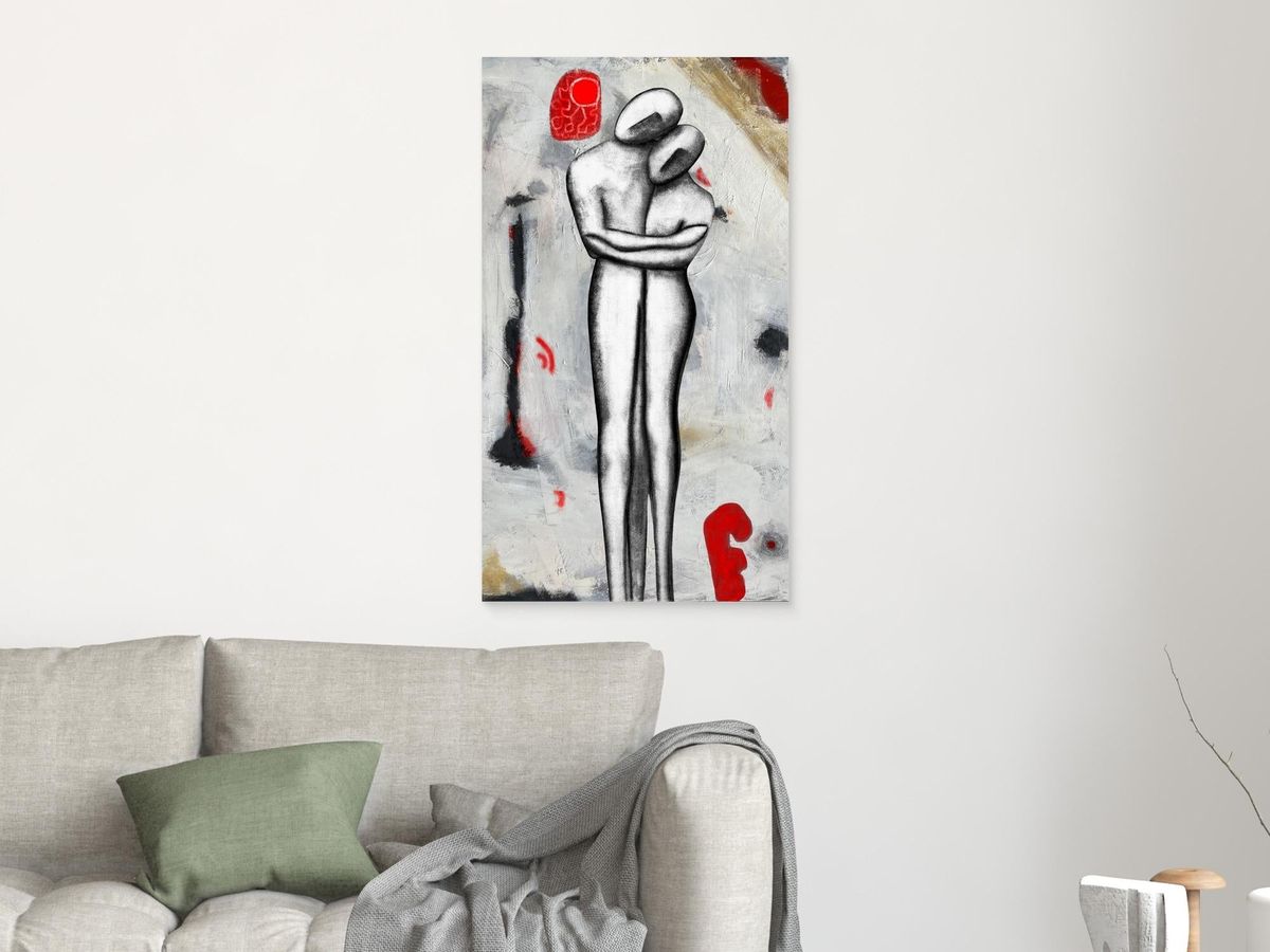 Room mockup: Solida Coesione 45 × 80 cm canvas print hanging above a light sofa on a warm off-white wall, daylight, soft cast shadow. Print shown true to proportion; unframed.